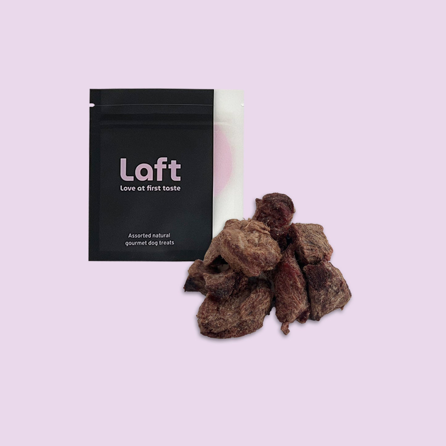 A black Laft Pet treat pouch placed next to a pile of freeze-dried emu dog treats on a light purple background.