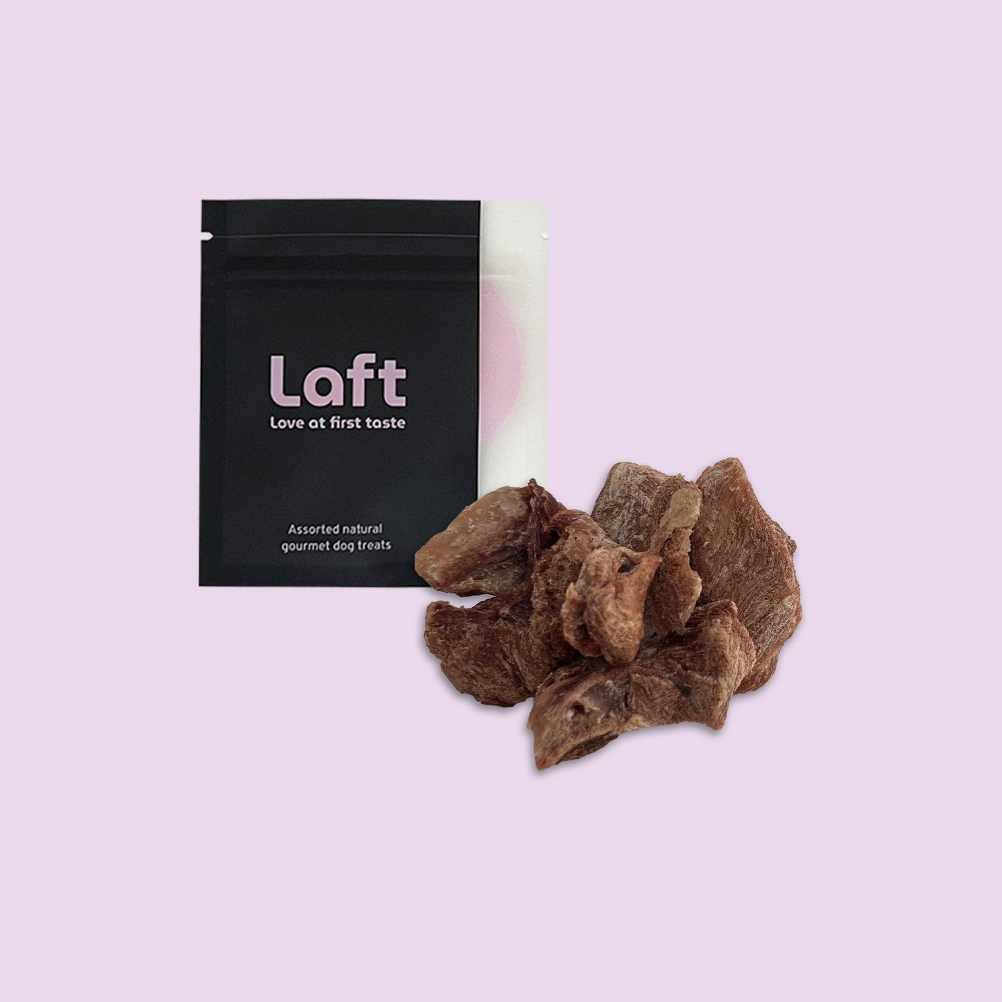 A black Laft Pet treat pouch placed next to a pile of freeze-dried turkey dog treats on a light purple background.