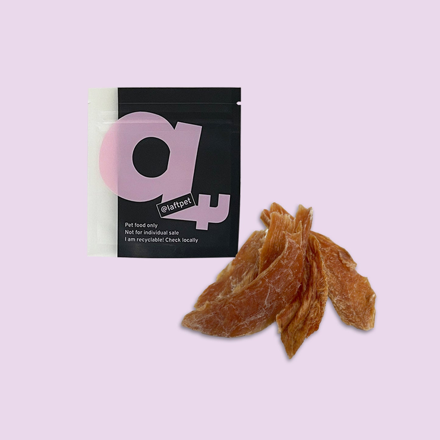 A black Laft Pet natural dog treat pouch placed next to a pile of dehydrated chicken jerky dog treats on a light purple background.