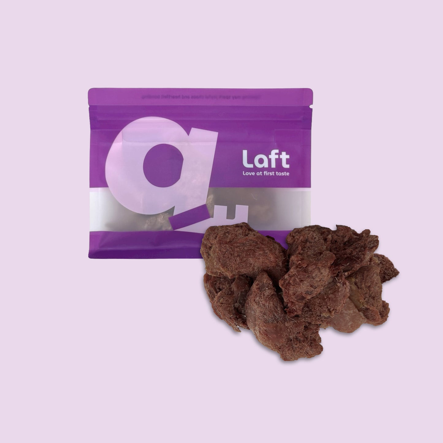 A purple Laft Pet natural dog treat pouch placed next to a pile of freeze-dried venison dog treats on a light purple background.