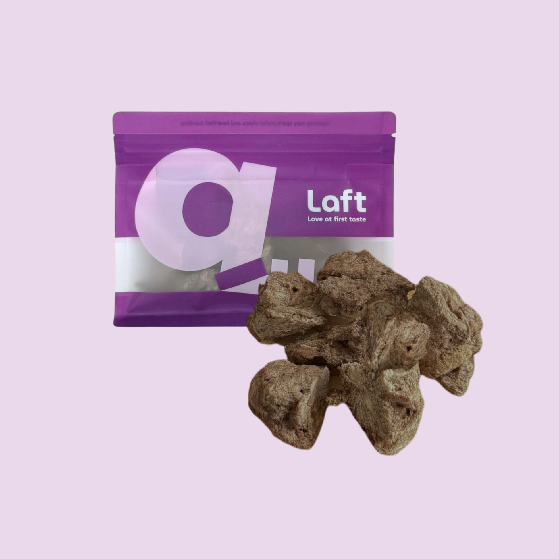 A purple Laft Pet natural dog treat pouch placed next to a pile of freeze-dried venison dog treats on a light purple background.
